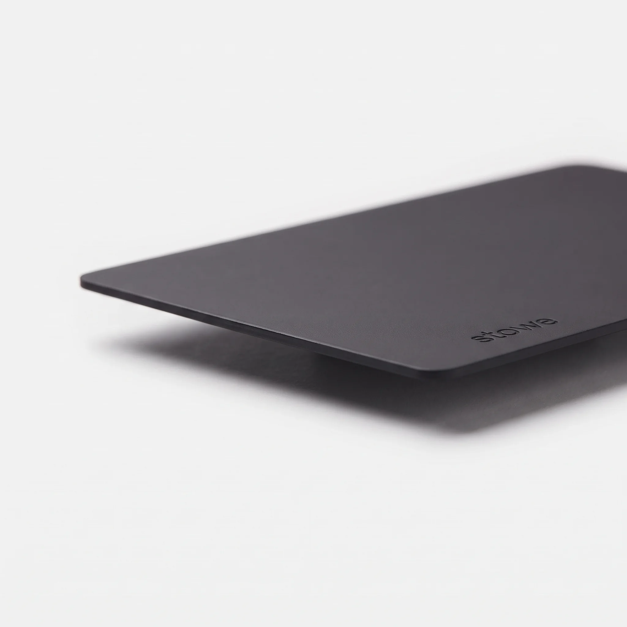 Graphite card lying flat, seen from a low angle, to show how thin it is.